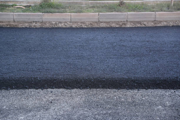 istock Freshly poured asphalt-Smoothing freshly laid asphalt with a rake 1995155684