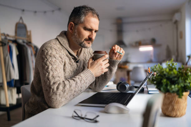 istock Mature Caucasian man working at his home office 1995157906