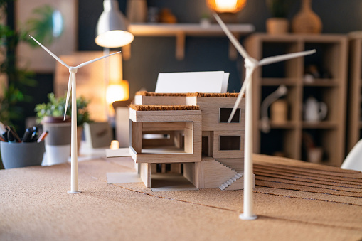 Architectural model of a modern house with wind turbines.