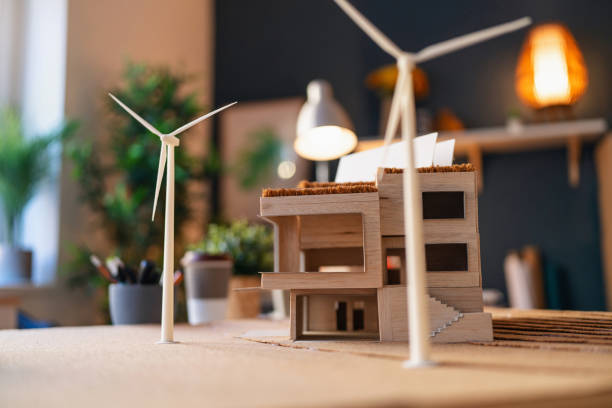 istock Architectural model of a modern house with wind turbines 1995158439