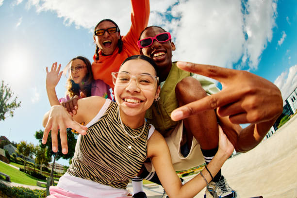 Wide angle shot of Gen Z group of friends hanging out together. Wide angle shot of Gen Z group of friends hanging out together. vibrant group stock pictures, royalty-free photos & images