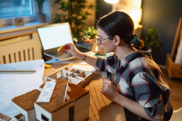istock Young female architect making an architectural model in her home office 1995162773