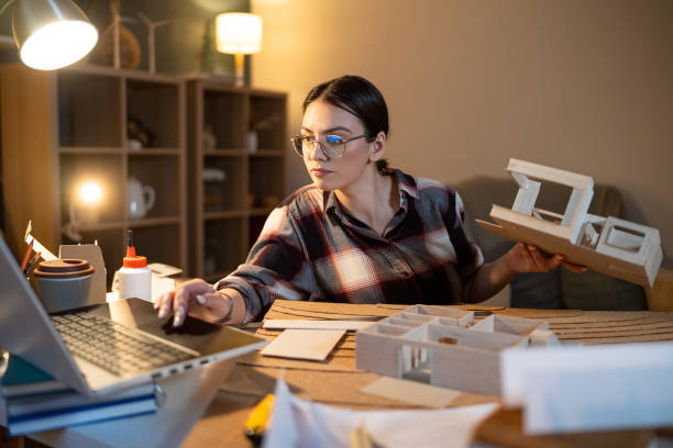 istock Young female architect making an architectural model in her home office 1995166018
