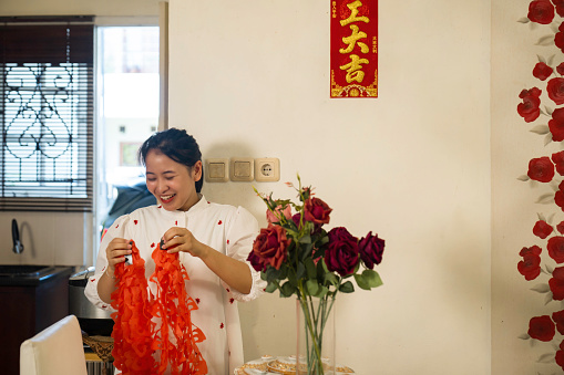 asian family decorating house for Chinese New Year