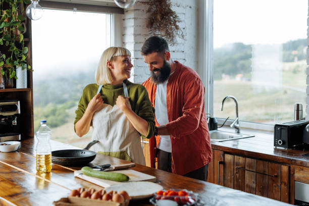 istock Caucasian couple cooking together. 1995170330