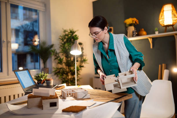 istock Young female architect making an architectural model in her home office 1995173700