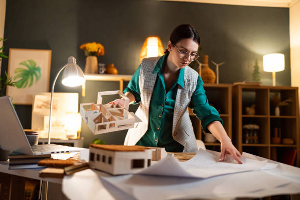 istock Young female architect making an architectural model in her home office 1995174892