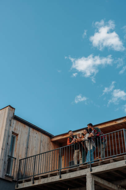 istock Friends on mountain cabin patio with copy space. 1995175990