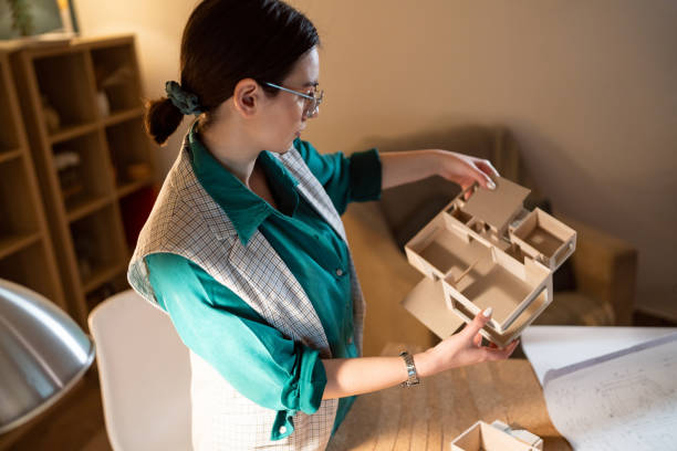 istock Young female architect making an architectural model in her home office 1995177630