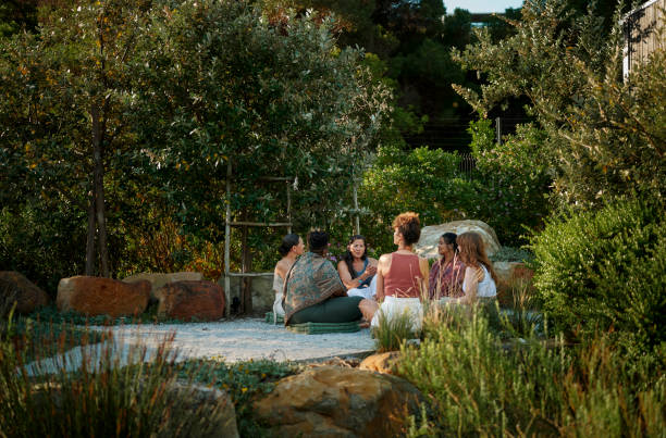 istock Women talking while sitting in a circle outdoors at a wellness retreat 1995179810