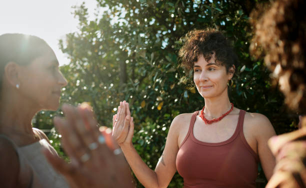 istock Smiling women doing a wellness exercise together outdoors during a retreat 1995181434
