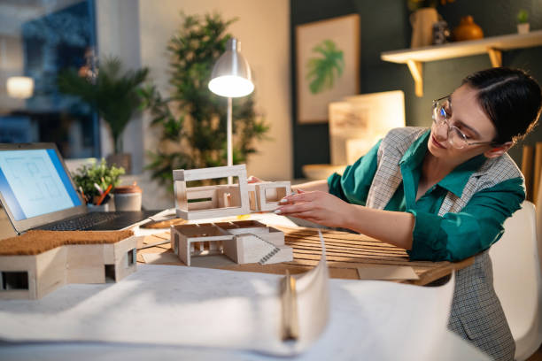 istock Young female architect making an architectural model in her home office 1995183584
