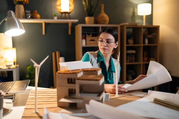 istock Young female architect working late in her home office 1995187316