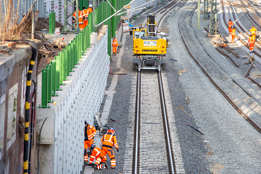 Modugno, Italy - 1 april 2019: Construction workers at work at Railway station. Construction of a new railway line at a city station.