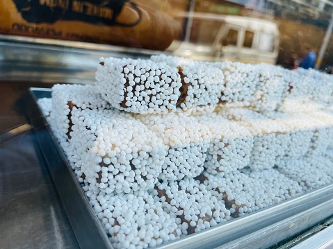 Bal mithai is a brown chocolate-like fudge, made with roasted khoya and coated with white balls made of sugar coated roasted poppy seeds. It is a popular sweet from Kumaon, India.