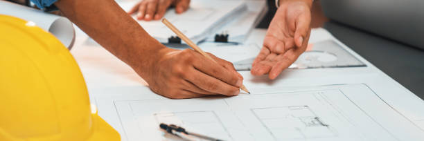 istock Engineer partner drawing and working on blueprint design together. Insight 1995191611
