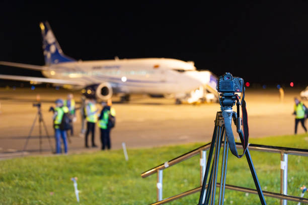 Bishkek, Kyrgyzstan - September 26, 2023: Closeup of digital camera on tripod during spotting at the airport at night