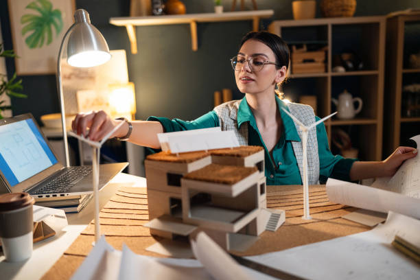 istock Young female architect making an architectural model in her home office 1995193229