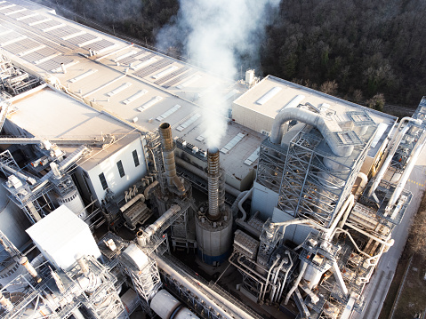 Drone stock photo of a big factory with smoking chimneys.