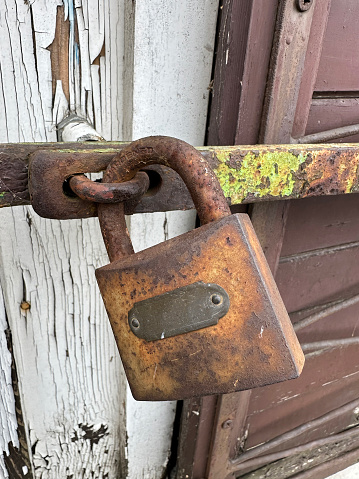 Old rusty padlock on the door