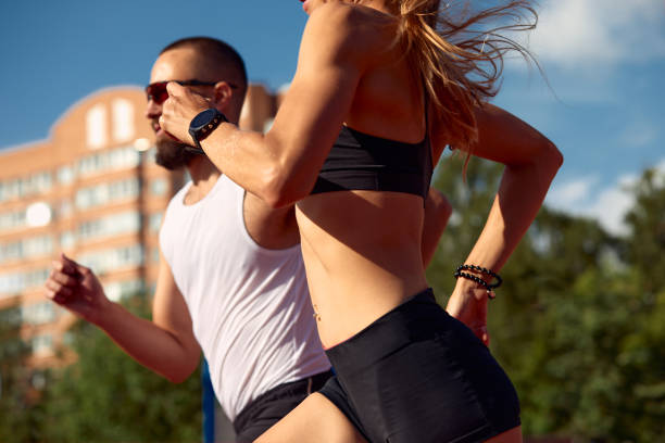 istock Woman and man jogging in the stadium 1995238804