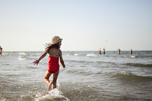 Little girl enjoying the sea in summer.