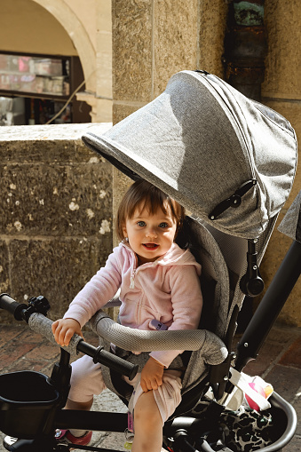 Portrait of a cute little girl in the stroller.