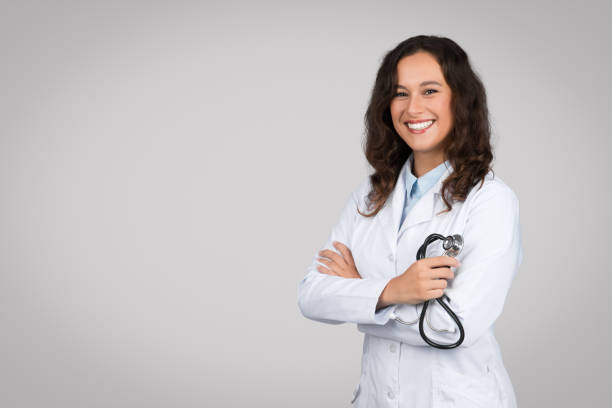 istock Professional help concept. Confident caucasian female medical practitioner in white coat holding stethoscope in hand 1995278688