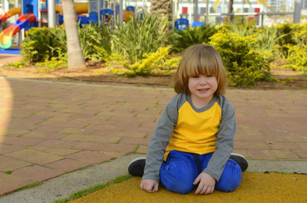 positive boy 4 years old at the playground. bright playground, palm trees, good mood. the face of the child, positive emotions - surprise child 4 5 years little boys zdjęcia i obrazy z banku zdjęć
