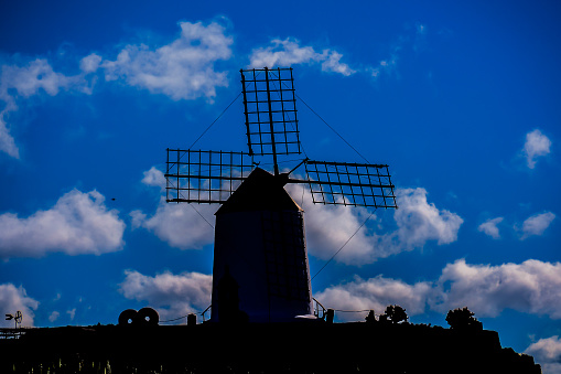 Historic Dutch windmill Lechtingen, under a partly cloudy blue sky, vertical