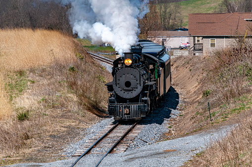 Coal burning K-36 steam locomotive moving toward camera on narrow gauge track.