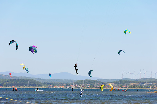 Izmir, Türkiye-07/28/2023: Large group of people kiteboarding.