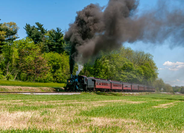 istock View of an Antique Restored Steam Passenger Train, Approaching, Blowing Black Smoke 1995295397