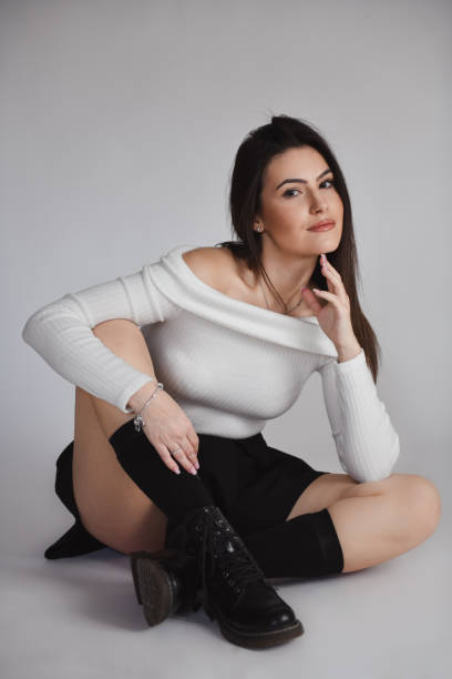 istock Contemplation Time For Gorgeous Female In White Open Shoulder Sweater On Grey Background 1995320479