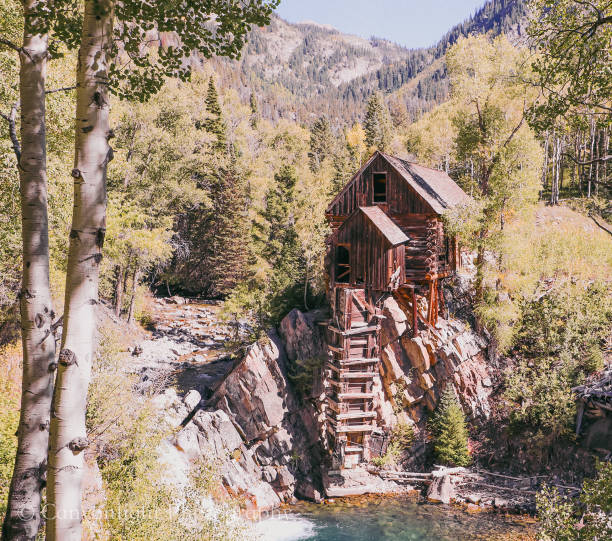 istock Wooden 1800s Powerhouse over River in the Fall 1995327854