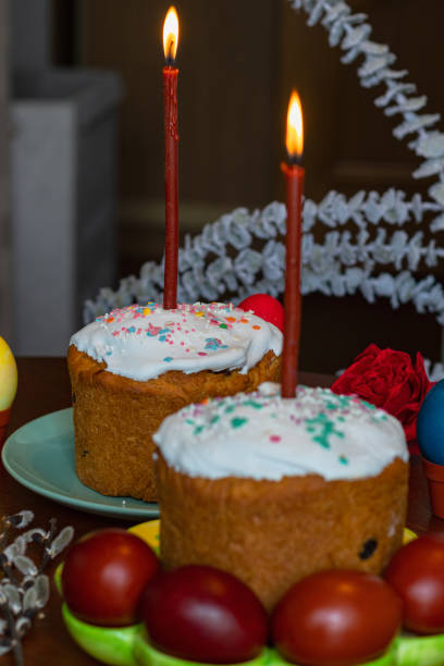 istock Elegant Easter cakes with burning candles on the dining table 1995328883