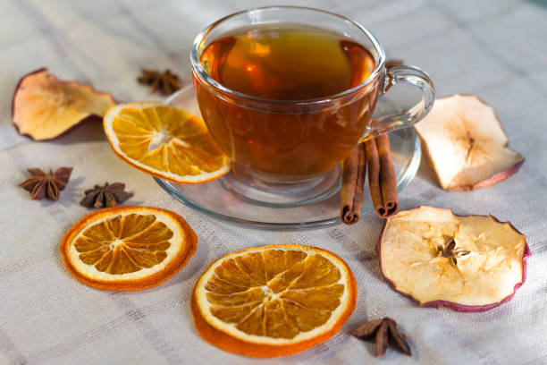 cup of tea and slices of dried orange - dried apple стоковые фото и изображения