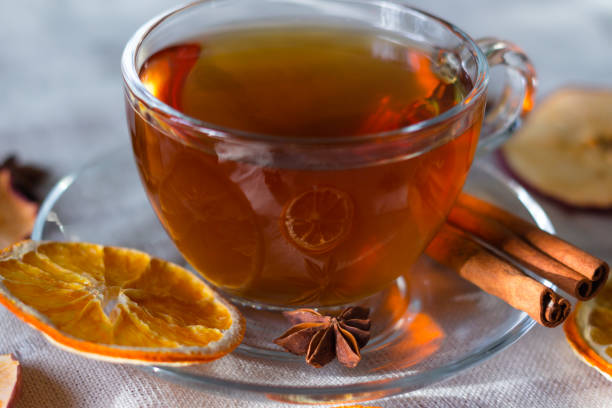 cup of tea and slices of dried orange - dried apple стоковые фото и изображения