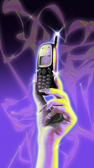Poster. Contemporary art collage. Female hand holds vintage mobile, cellphone against creative gradient background. Trendy Y2K style and retro futurism. Concept of nostalgy, technology, digital age.