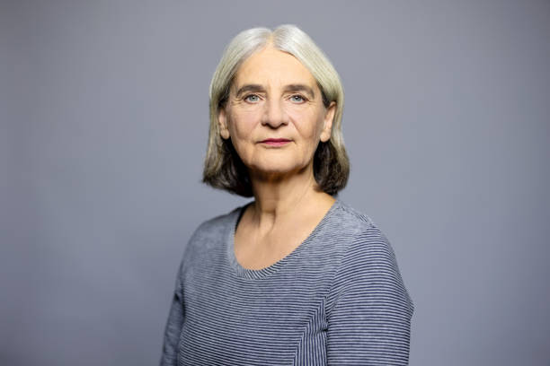 istock Mature woman staring at camera against grey background 1995368343