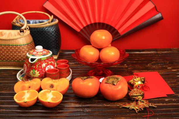 istock The Chinese hot tea set with orange fruit and a red envelope called AngPao and ornament accessories for Chinese New Yea 1995389941