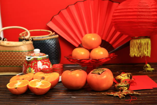 istock The Chinese hot tea set with orange fruit and a red envelope called AngPao and ornament accessories for Chinese New Yea 1995389946