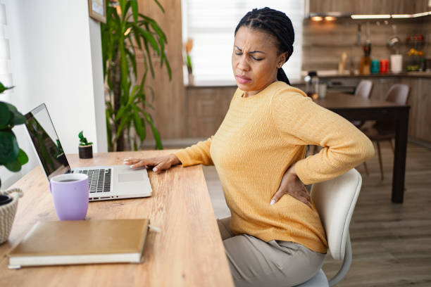 istock Black woman experiencing back pain while working at home 1995401528