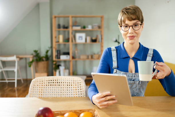 istock Portrait of a woman enjoying coffee and using tablet 1995414752
