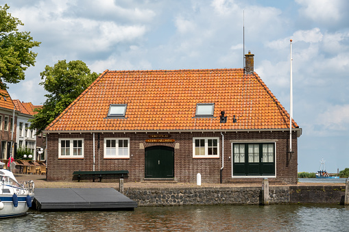 Building of former fish auction, Vischafslag, in Oosterhaven of city of Medemblik, Noord-Holland, Netherlands