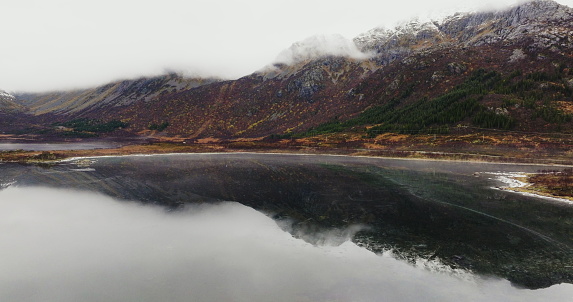Mystic Mornings in Lofoten: Fog-Enshrouded Peaks and Mirror-Like Lake. High quality 4k footage