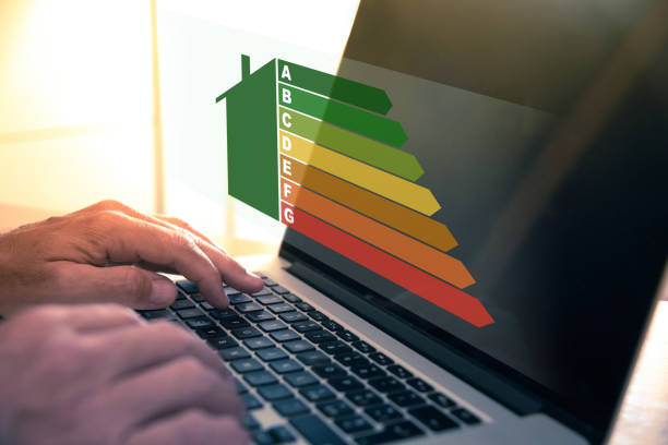 istock Man calculating energy buildings efficiency class. Ecological and bio energetic house concept. 1995431188