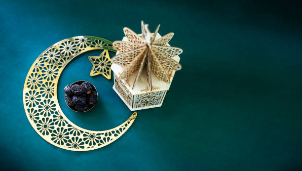 istock Flatly image of crescent moon with dates and lantern lamp 1995436906