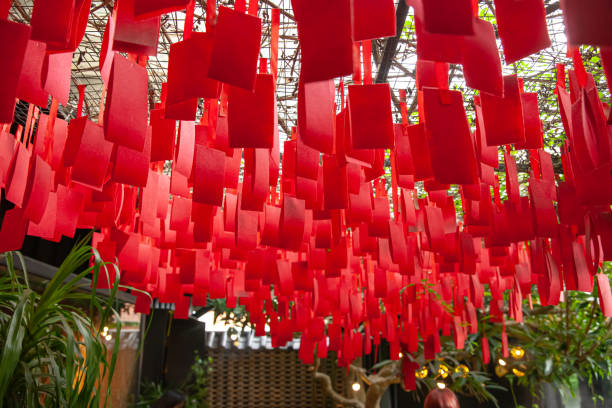 istock Colorful red paper decorations hanging from the ceiling in a temple for a celebration 1995449632