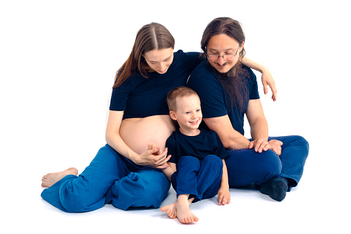 Pregnant mother with daughters in the nature